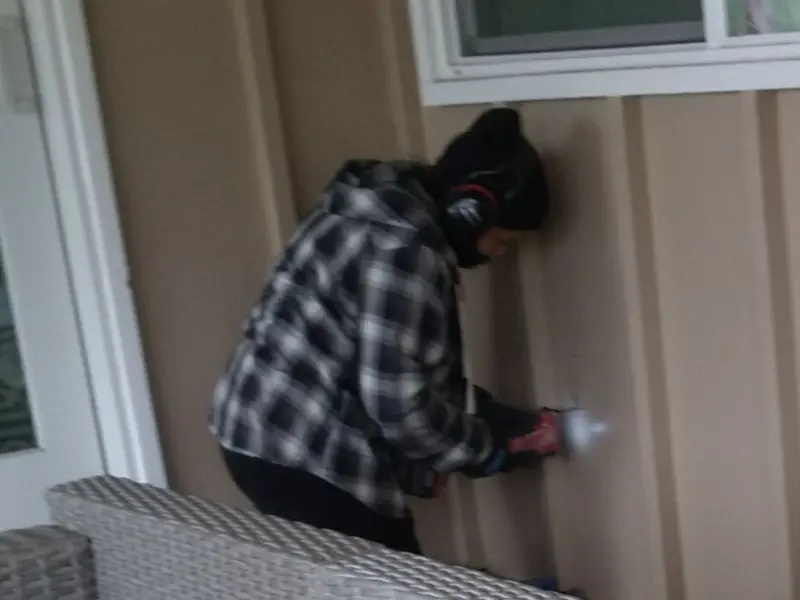 Professional electrician installing an exterior outlet in Hooper